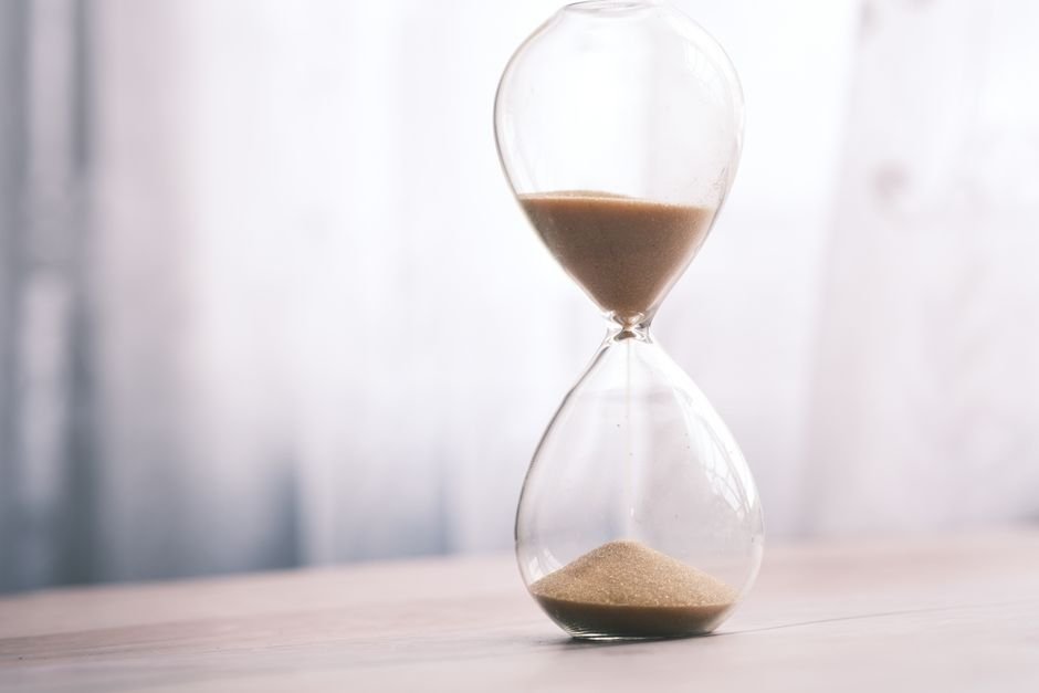 An hourglass with sand running through it on a table